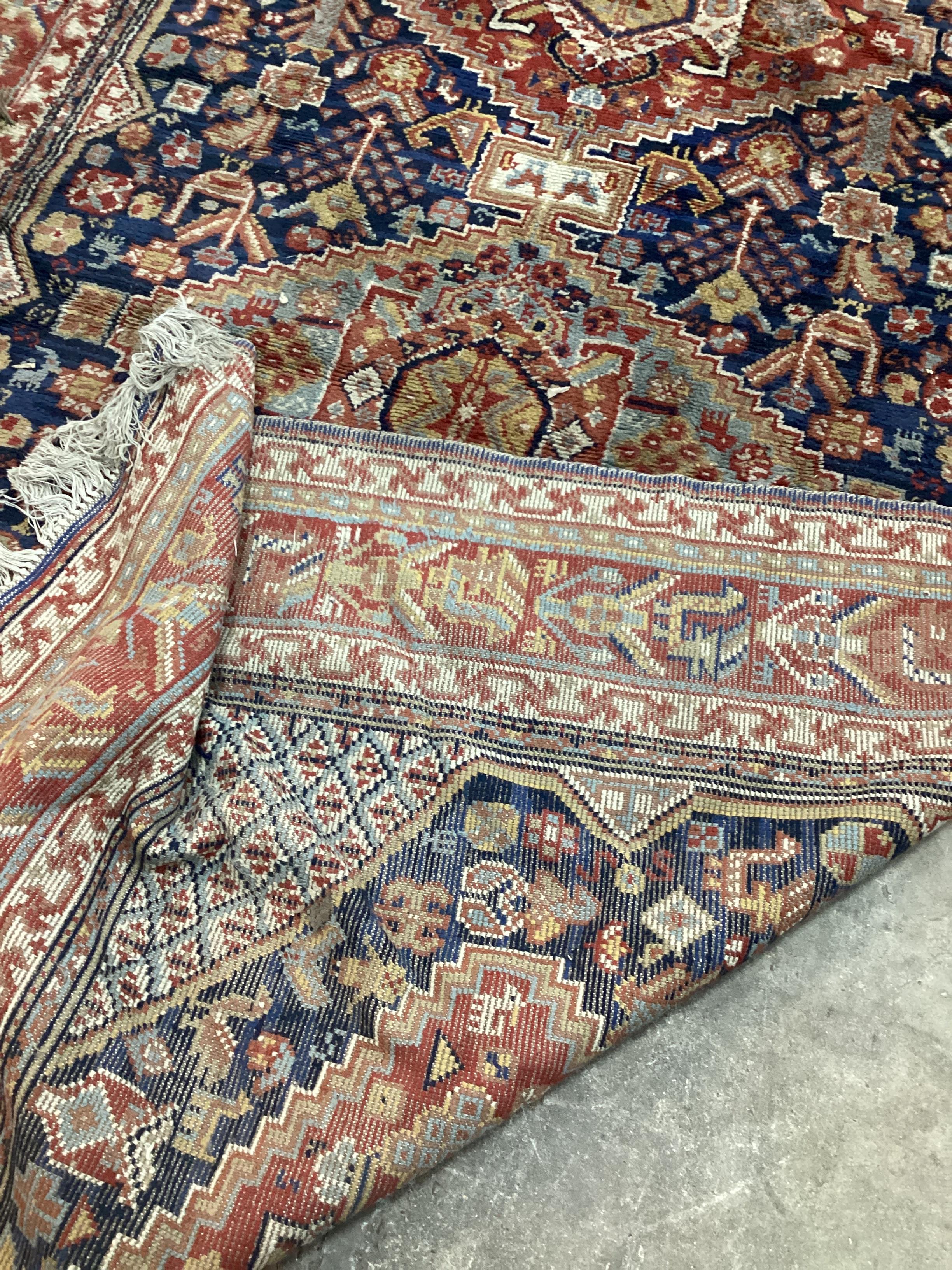 A Caucasian blue ground carpet (holed), 300 x 198cm